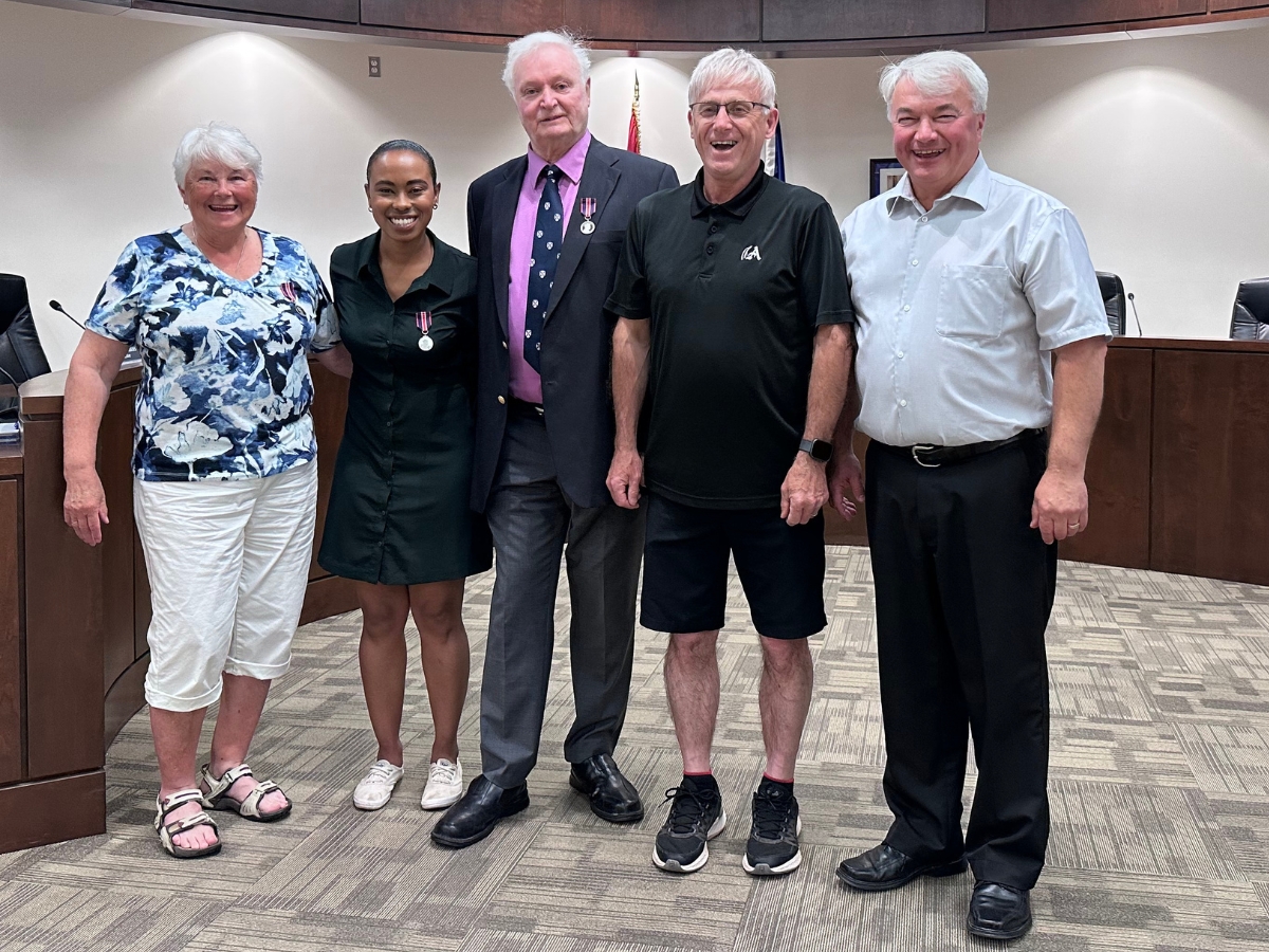 Photo of three local recipients of the King Charles the Third medal, posing with the mayor and a Town Councillor.